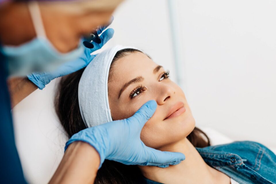 Woman receiving facial skin evaluation in Jackson, MS