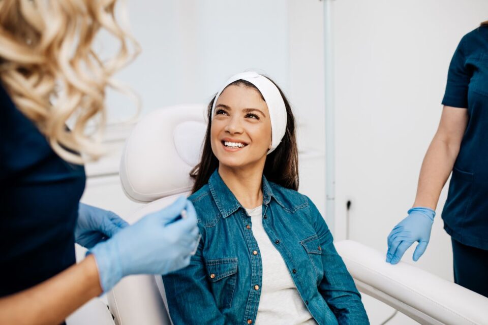 Woman smiling during cosmetic consultation in Jackson, MS