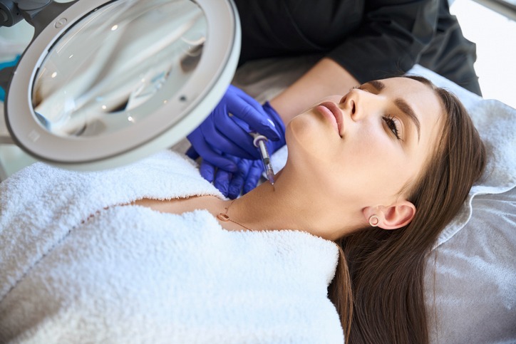 Medical professional performing neck contouring treatment in Jackson, MS